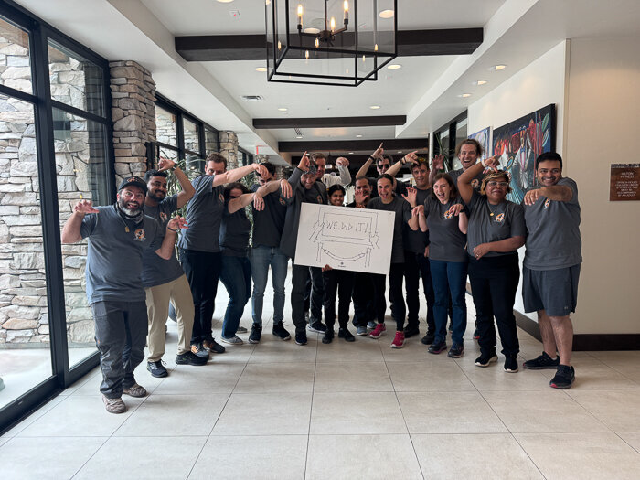 STAR crew holding a mission sign