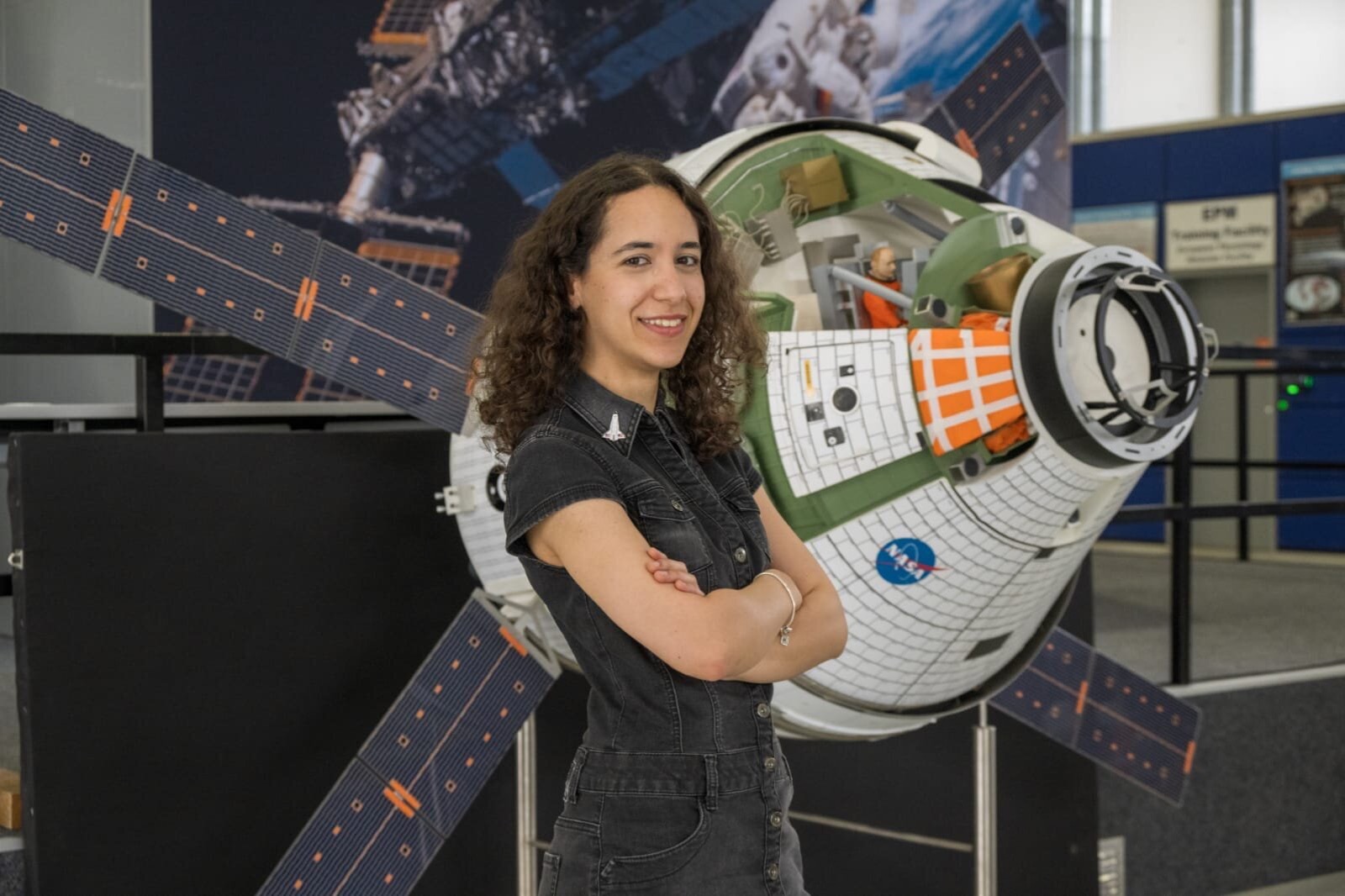 Emily Apollonio holding an analog spacesuit helmet